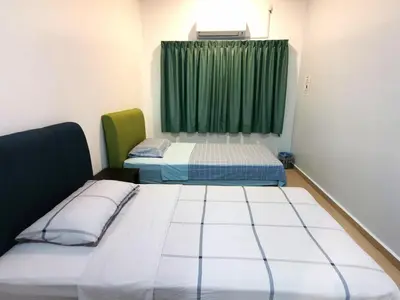 a room with two beds and a window at Calm in Kuala Kubu Bharu in Kuala Kubu Baharu
