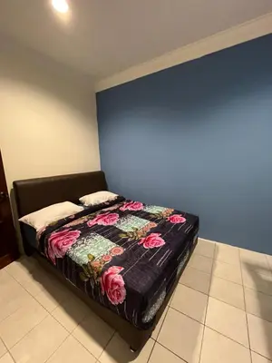 a bed in a room with a blue wall at Big Dreams Double Story House in Tanah Rata