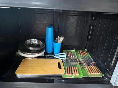 a drawer with a cutting board and some utensils at Slim Village Palm House - 2 rooms, 8 beds, 8 persons in Slim River