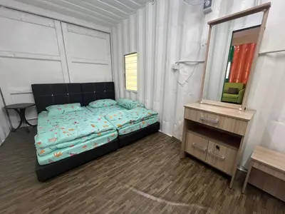 a bedroom with a bed and a dresser and a mirror at Slim Village Palm House - 2 rooms, 8 beds, 8 persons in Slim River