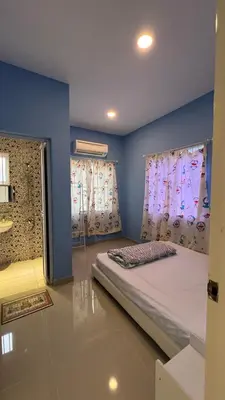 a bedroom with a bed and two windows at 515 Nana’s Homes in Sekinchan in Sekincan