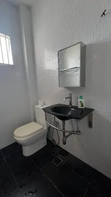 a bathroom with a white toilet and a sink at 515 Nana’s Homes in Sekinchan in Sekincan