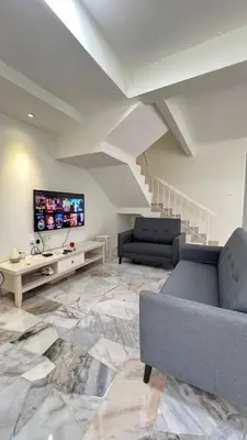 a living room with a couch and a tv at 515 Nana’s Homes in Sekinchan in Sekincan
