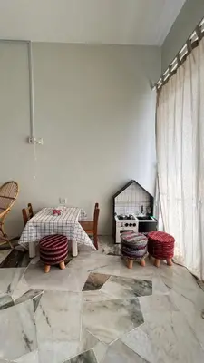 a living room with a table and two stools at 515 Nana’s Homes in Sekinchan in Sekincan