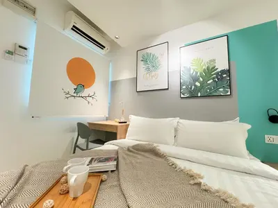 a bedroom with a bed and a desk in it at Apple 1 Hotel Gurney in George Town