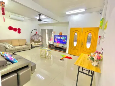 a living room with a couch and a tv at Happy Gather Homestay \u6b22\u805a\u9601 in Ipoh