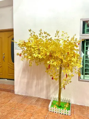 a small tree in a container in a room at Happy Gather Homestay \u6b22\u805a\u9601 in Ipoh