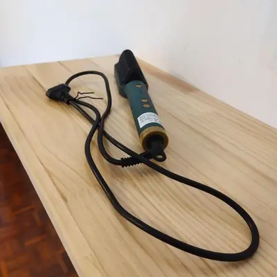 a flashlight with a cord on a wooden table at Happy Gather Homestay \u6b22\u805a\u9601 in Ipoh