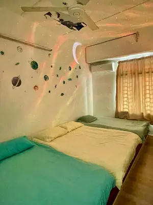 a bed in a room with a rock wall at HAPPY GATHER HOMESTAY in Ipoh