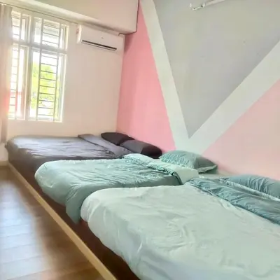 two beds sitting next to each other in a room at HAPPY GATHER HOMESTAY in Ipoh