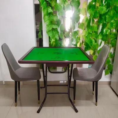 a table with two chairs and a green table at HAPPY GATHER HOMESTAY in Ipoh