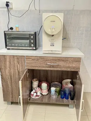 a microwave and a toaster oven sitting on a counter at HAPPY GATHER HOMESTAY in Ipoh