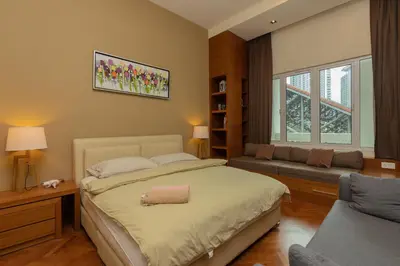 a bedroom with a large bed and a couch at SQSu in Tanjong Tokong