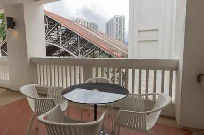 a balcony with a table and chairs and a bridge at SQSu in Tanjong Tokong
