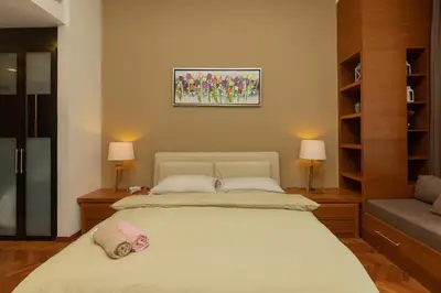 a bedroom with a bed with two pillows on it at SQSu in Tanjong Tokong