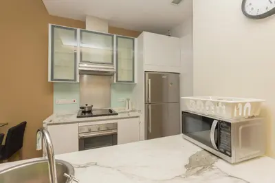 a kitchen with a sink and a microwave at SQSu in Tanjong Tokong