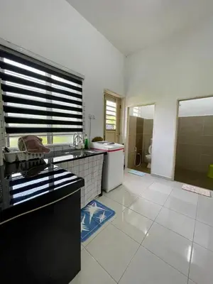 a kitchen with a sink and a counter top at Rumah Kami Homestay in Butterworth