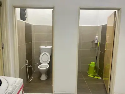 a bathroom with a toilet in a bathroom stall at Rumah Kami Homestay in Butterworth