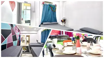 a room with a table and chairs and a bed at Penang Dream Banglo Sleeps 40 in Tanjung Bungah