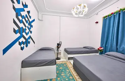 two beds in a room with blue and white at Penang Dream Banglo Sleeps 40 in Tanjung Bungah