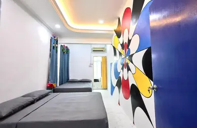 a bedroom with two beds and a blue door at Penang Dream Banglo Sleeps 50 in Tanjung Bungah