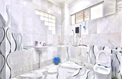 a bathroom with a toilet and a sink at Penang Dream Banglo Sleeps 50 in Tanjung Bungah
