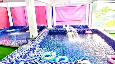a indoor swimming pool with a water fountain at Penang Dream Banglo Sleeps 65 in Tanjung Bungah