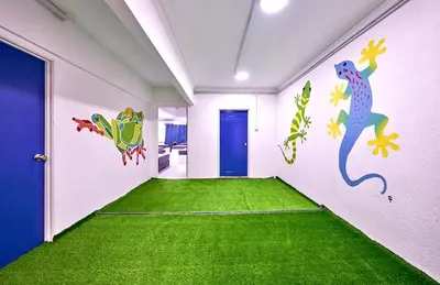 a hallway with a green carpet and a blue door at Penang Dream Banglo Sleeps 65 in Tanjung Bungah