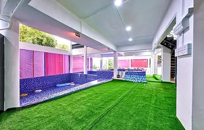 a room with blue chairs and green carpet at Penang Dream Banglo Events up to 120 Pax in Tanjung Bungah