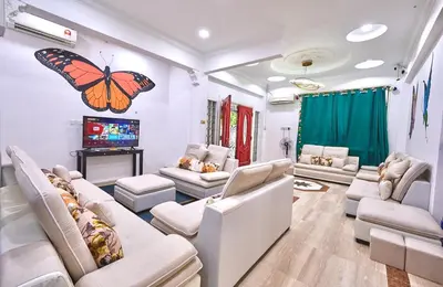a large living room with a butterfly on the wall at Penang Dream Banglo Events up to 120 Pax in Tanjung Bungah