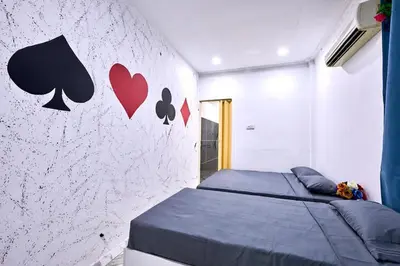 a bedroom with a bed and a wall with hearts at Penang Dream Banglo Sleeps 22 in Tanjung Bungah