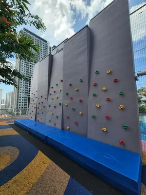 a climbing wall with umbrellas in a building at Urban Suite - George Town in Jelutong