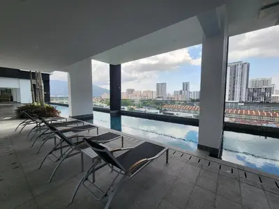 a group of chairs and tables on top of a building at Urban Suite - George Town in Jelutong