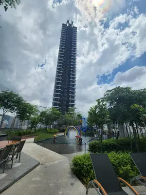 a tall building with a fountain in a park at Urban Suite - George Town in Jelutong
