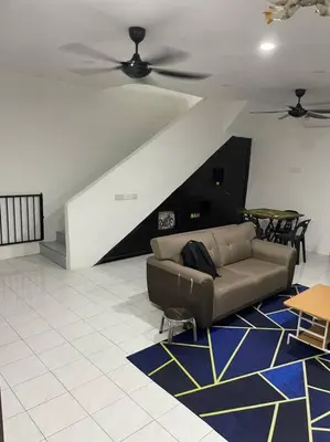 a living room with a couch and a ceiling fan at SunShine HomeStay in Bukit Mertajam