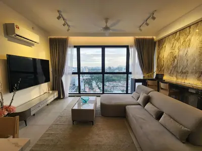 a living room with a couch and a large window at Urban Suites - Penang in Jelutong
