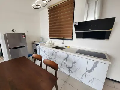 a kitchen with a sink and a wooden table at Urban Suites - Penang in Jelutong
