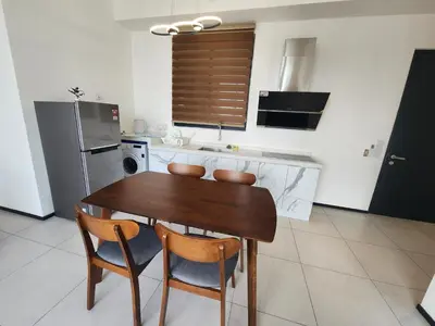 a kitchen with a wooden table and two chairs at Urban Suites - Penang in Jelutong