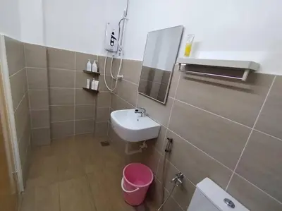 a bathroom with a sink and a mirror at Nana's Sitiawan Home Stay, Victoria cottage in Sitiawan