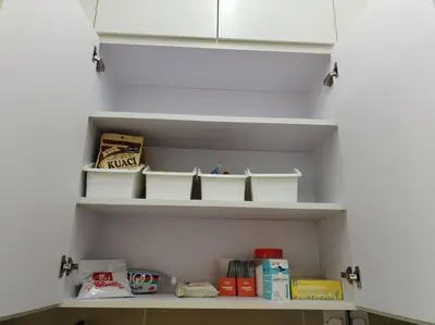 a shelf in a kitchen with white shelves at Nana's Sitiawan Home Stay, Victoria cottage in Sitiawan