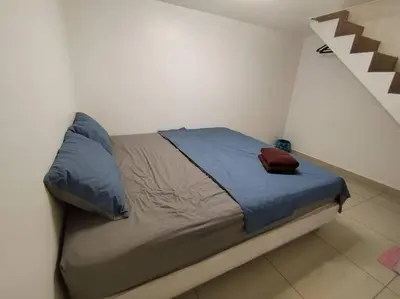 a bed in a small room with at Nana's Sitiawan Home Stay, Victoria cottage in Sitiawan