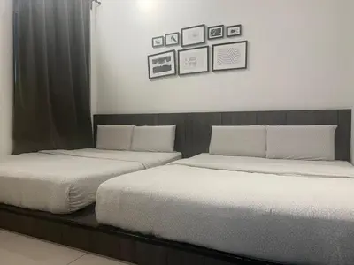 two beds sitting next to each other in a bedroom at Ipoh Town Majestic 3R2B 10paxs Remi Suite in Ipoh