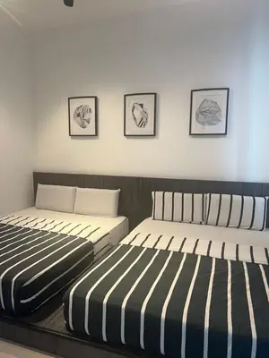 two beds sitting next to each other in a bedroom at Ipoh Town Majestic 3R2B 10paxs Remi Suite in Ipoh