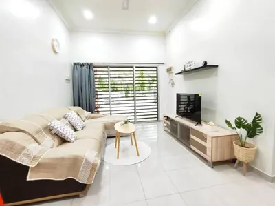 a living room with a large couch and a tv at Bidor Family Choice 3 Bedrooms WIFI in Bidur