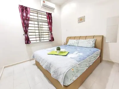 a bedroom with a bed with a tray on it at Bidor Family Choice 3 Bedrooms WIFI in Bidur