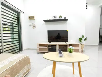 a living room with a tv and a table at Bidor Family Choice 3 Bedrooms WIFI in Bidur