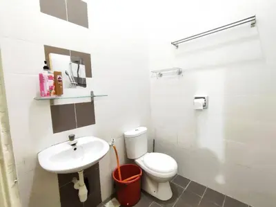 a white bathroom with a toilet and a sink at Bidor Family Choice 3 Bedrooms WIFI in Bidur