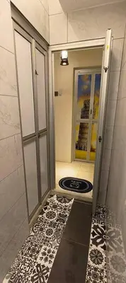 a bathroom with a shower with a black and white floor at Wi-Fi 100MB free Ipoh Homefeel 4 rooms Tatami S48 in Ipoh