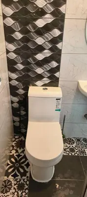 a bathroom with a white toilet and a black and white wall at Wi-Fi 100MB free Ipoh Homefeel 4 rooms Tatami S48 in Ipoh