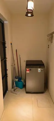 a room with a small refrigerator in the corner of a room at Wi-Fi 100MB free Ipoh Homefeel 4 rooms Tatami S48 in Ipoh